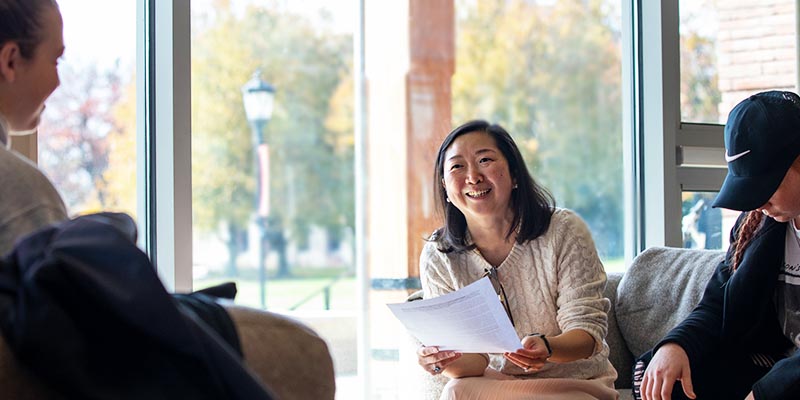 Professor talking with students t Bryn Athyn College