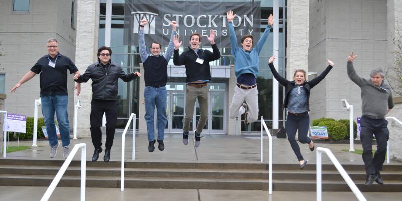 Bryn Athyn College students and professors jumping together off the steps at the conference for the Mid Atlantic Chapter of the Ecological Society of America