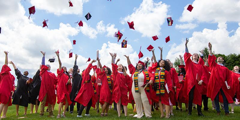 Class of 2022 graduates toss their graduation hats in celebration