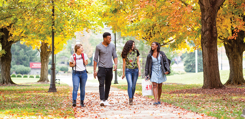 Bryn Athyn College students walking to class under the fall leaves