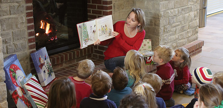 Education reads to early education class by a cozy fire in the Brickman Center at Bryn Athyn College