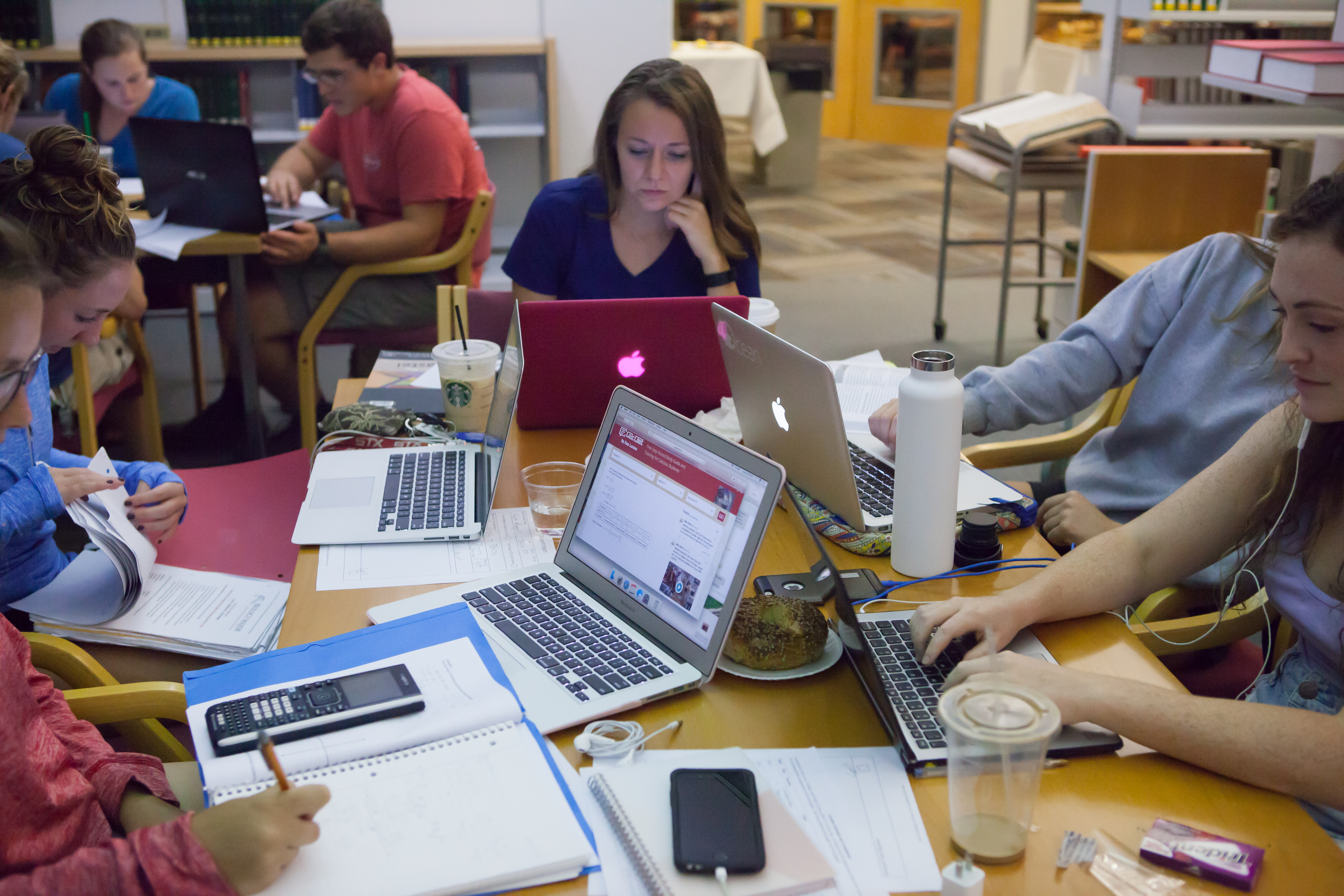 Bryn Athyn College students working on laptops in library