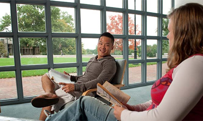 Bryn Athyn College students talking in the library