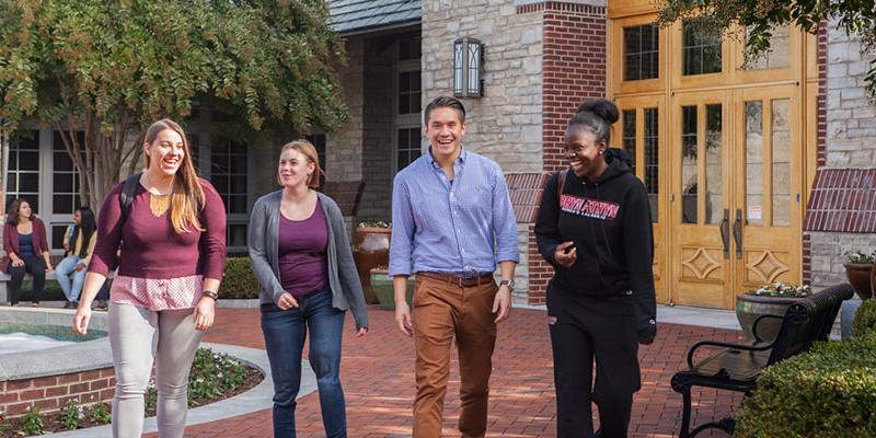 Students walking around the Brickman fountain