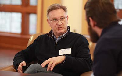 Bryn Athyn College alumni speaking with a student