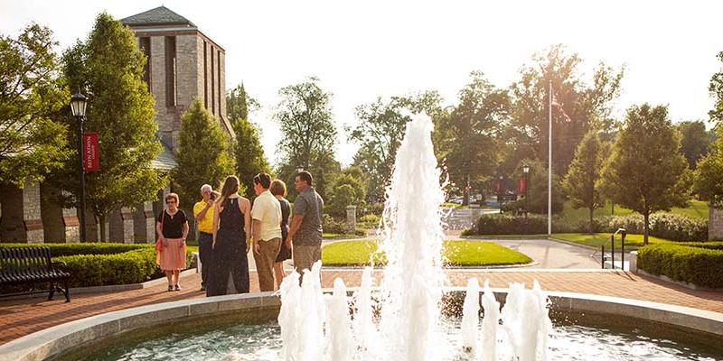 Bryn Athyn College students and parents taking a picture in front of the Brickman Fountain