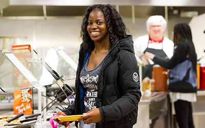 Bryn Athyn College student getting food from the dinging hall