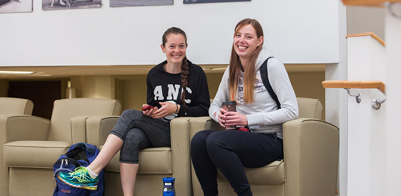 Bryn Athyn College students sitting on chairs and smiling