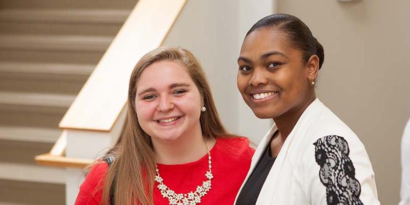 Two students smiling