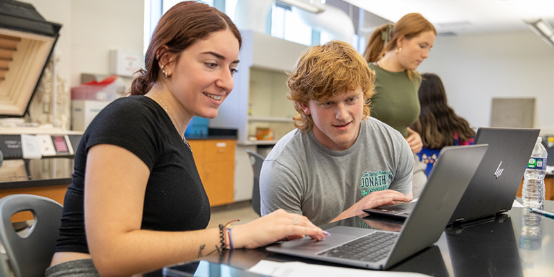 Students work together on a computer