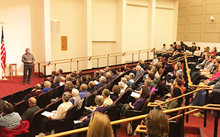 A large audience attends a lecture in the Pendleton Hall Auditorium at Bryn Athyn College