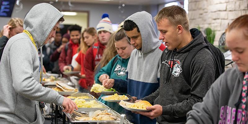 Bryn Athyn College students getting food in the dining hall