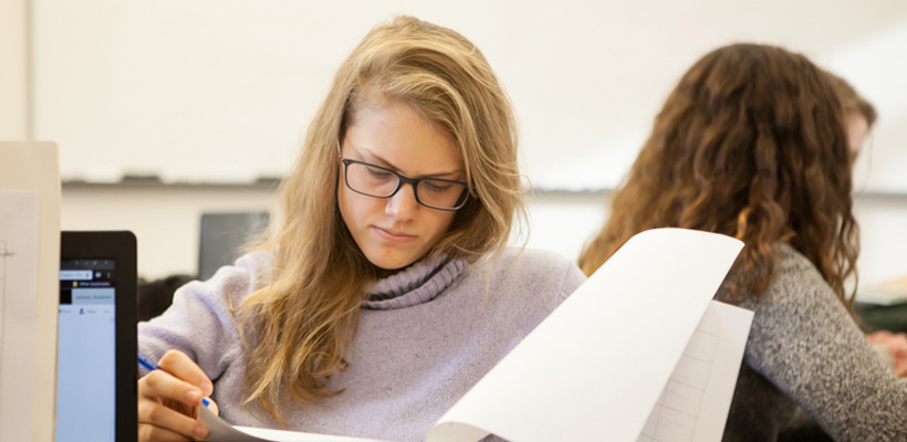 Bryn Athyn College student looks through a paper