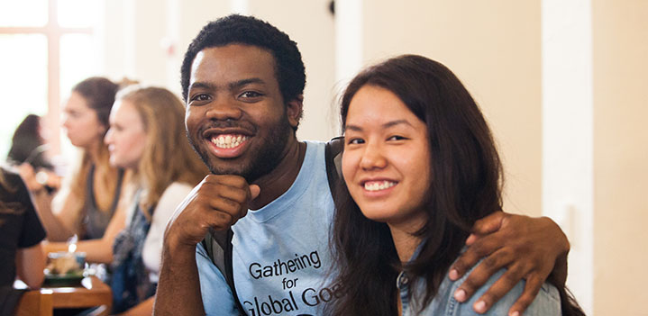 Students smile eating lunch in the Brickman Dining Hall