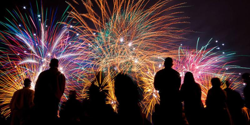 Fireworks disply with silouettes of people watching