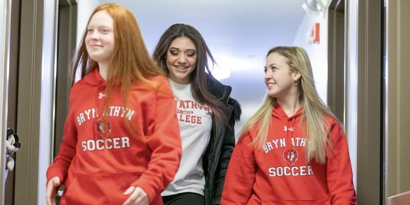 Students laugh together as they make thier way down the hallway of one of the residence life halls at Bryn Athyn College