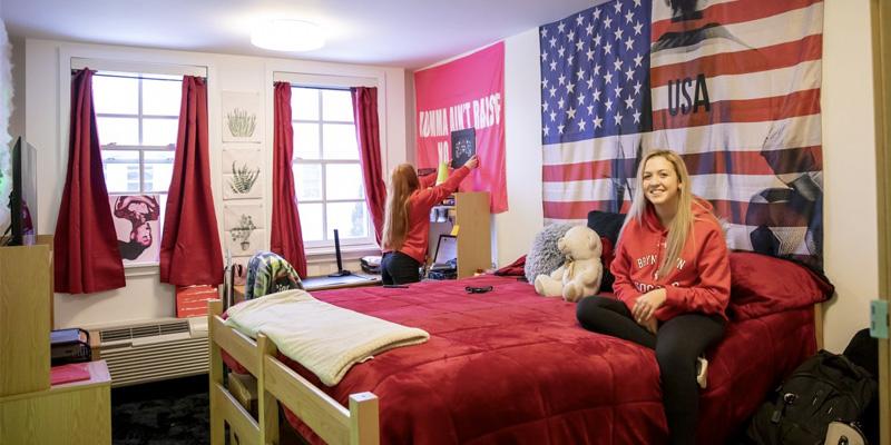 Students hanging out and decorating their room in one of the comfortable residence halls