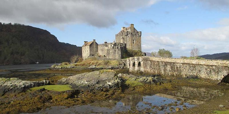 A castle and bridge in a lake in Scotland