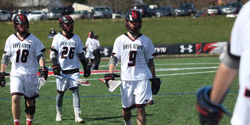 Lacrosse athletes prepare to play on the field