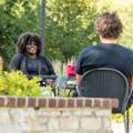 Students speaking on the outdoor patio