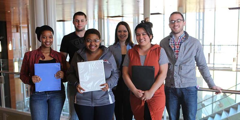 Bryn Athyn College Students holding their senior presentation folders in the Doering Center