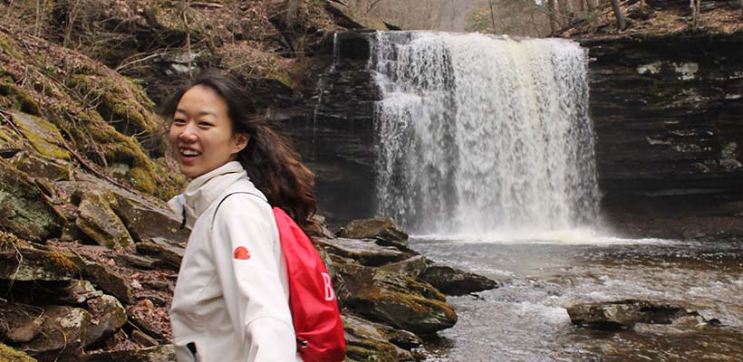Bryn Athyn College student hiking near waterfall